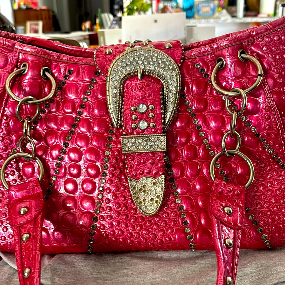 Pink snake looking purse has all of the  diamonds and chains for today’s world